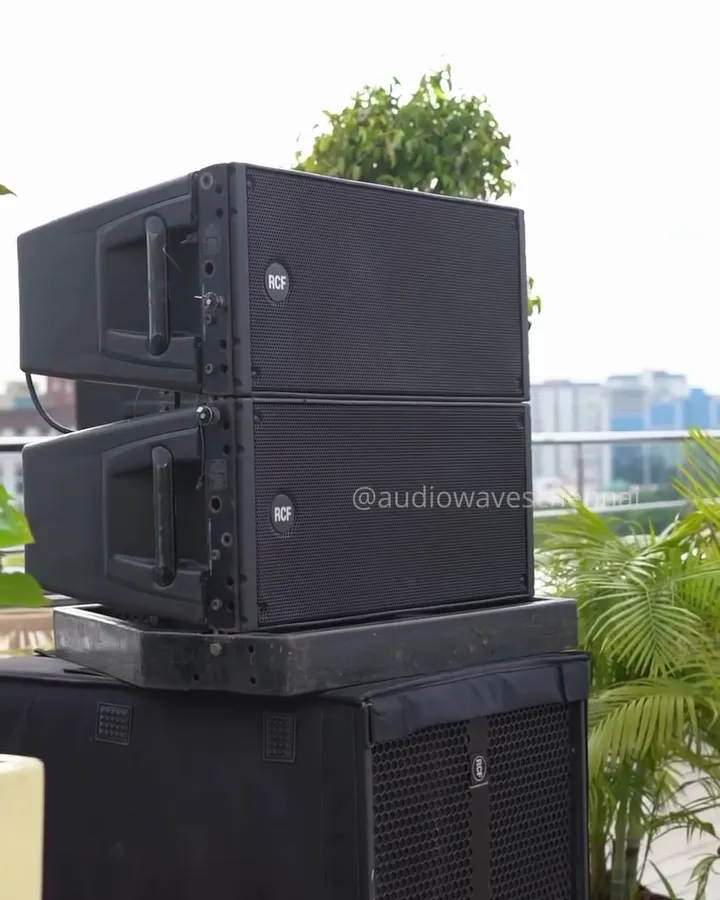 Line-array speakers stacked on subwoofers on the rooftop